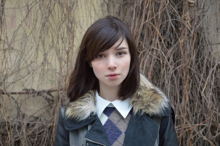 Woman with brown hair and fur-lined jacket