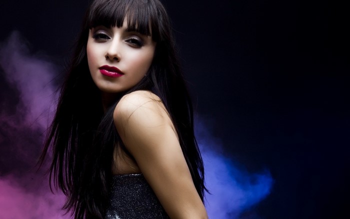 Woman with long dark hair and red lipstick