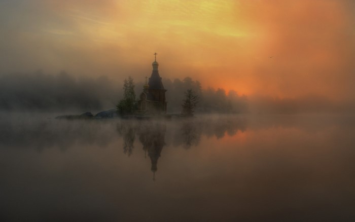 Church on an island in the mist at sunrise