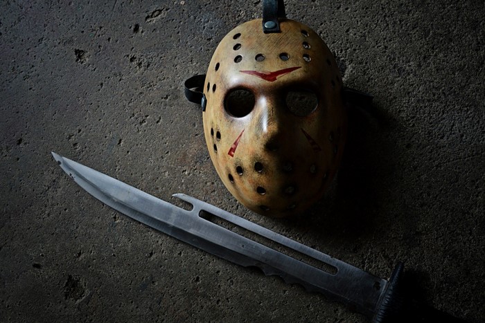 Jason Voorhees mask and machete on concrete