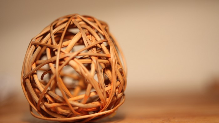 Woven sphere on a wooden surface