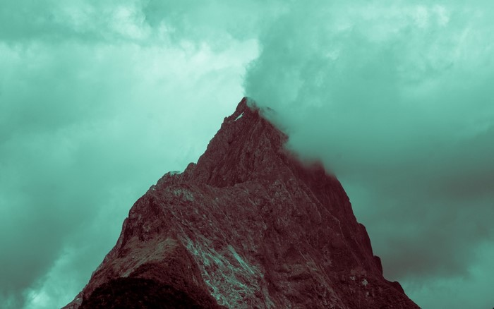 A jagged mountain peak shrouded in mist