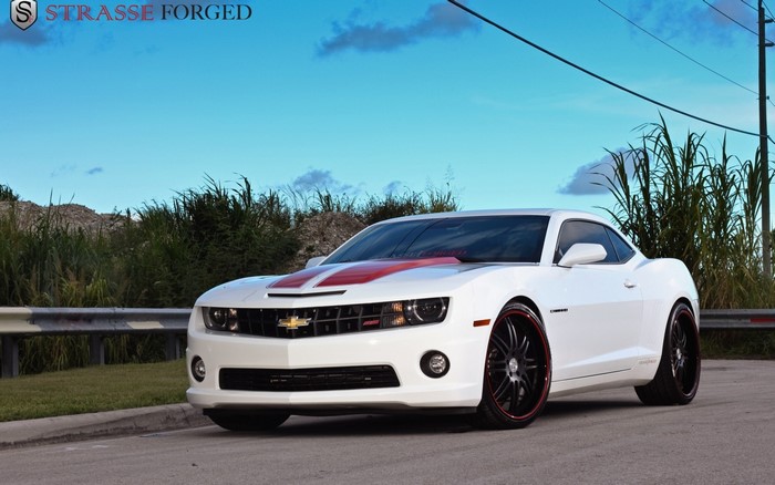 White Chevrolet Camaro with red stripes and custom wheels
