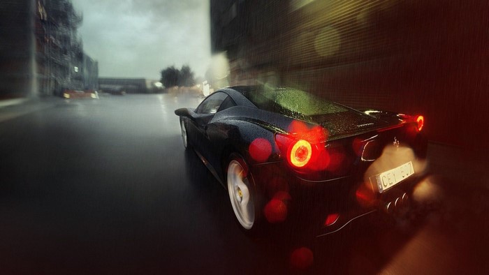 Black Ferrari driving on a rainy city street