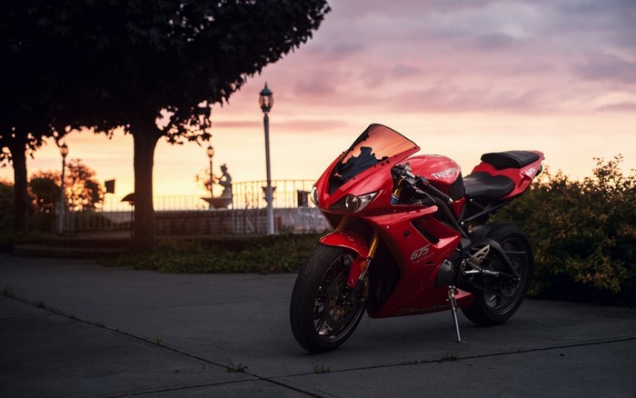 Red Triumph Daytona 675 motorcycle at sunset