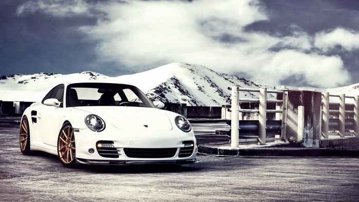 White Porsche 911 GT2 parked on a snowy mountain road