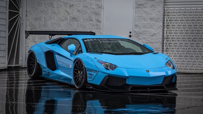 Blue Lamborghini Aventador with a large rear wing