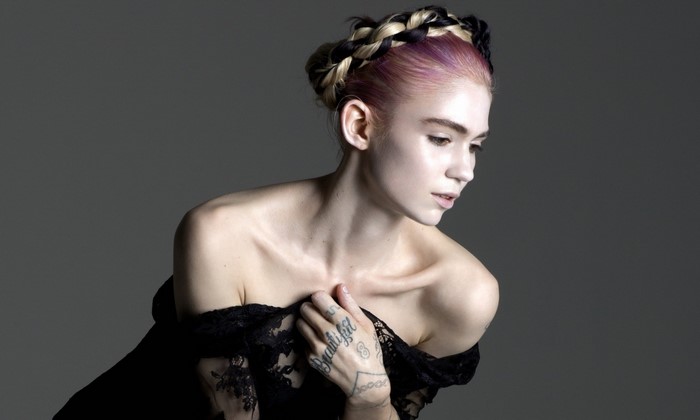 Grimes with braided hair and black lace dress