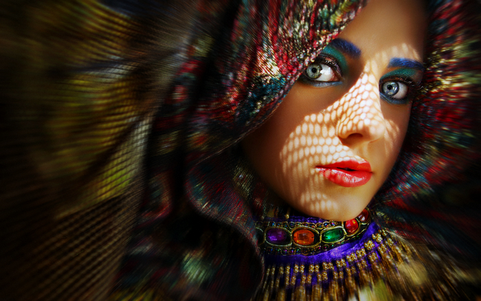 Woman with colorful headdress and makeup