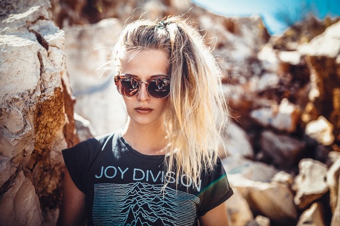 Woman wearing sunglasses and Joy Division t-shirt