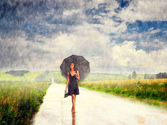 Woman with umbrella walking in the rain