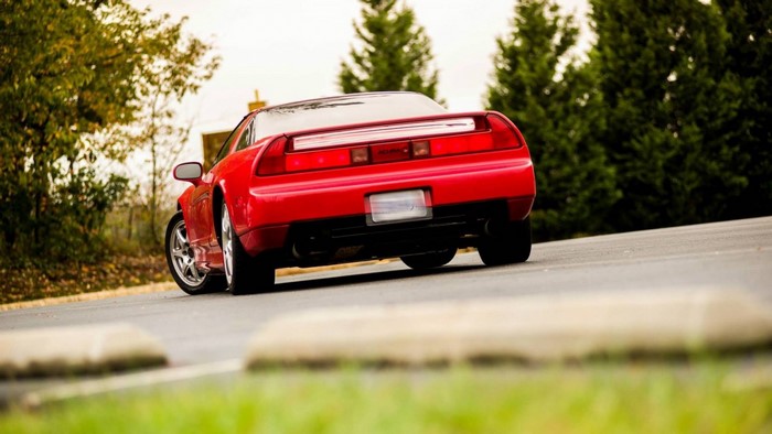 Red Acura NSX sports car on a road