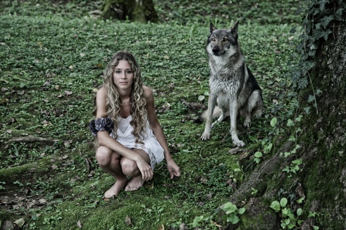 Woman and wolf in a forest