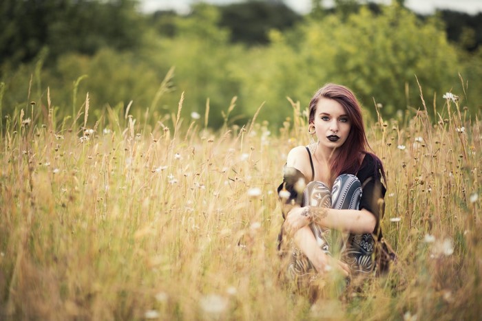 Woman sitting in a grassy field