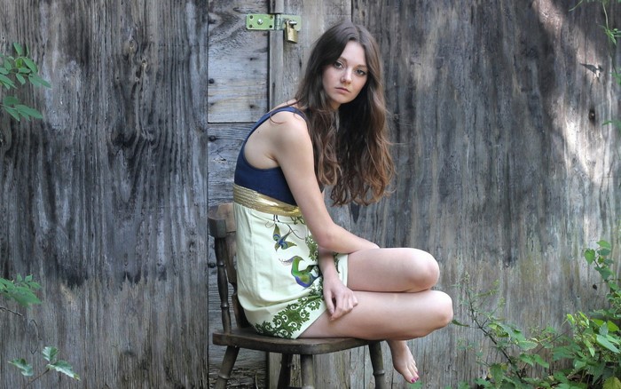Woman Sitting on Chair in Forest with Floral Dress