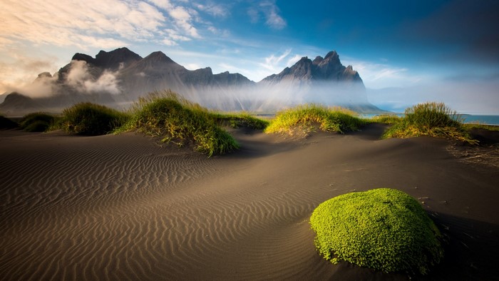 Sand dunes and mountains in Iceland at sunrise