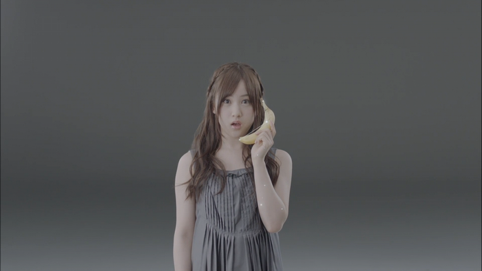 Woman holding a banana to her ear