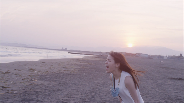 Woman shouting on a beach at sunset