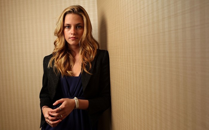Kristen Stewart in a black blazer and blue dress