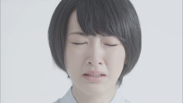 Asian woman crying with tears on her face