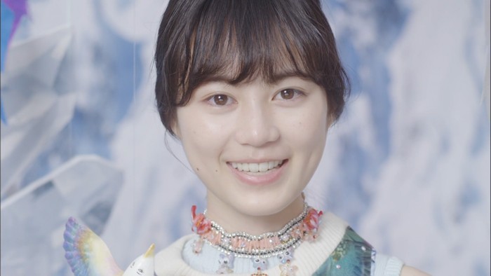 Asian woman with black hair and brown eyes smiling