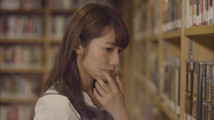 Asian woman with long brown hair in a library