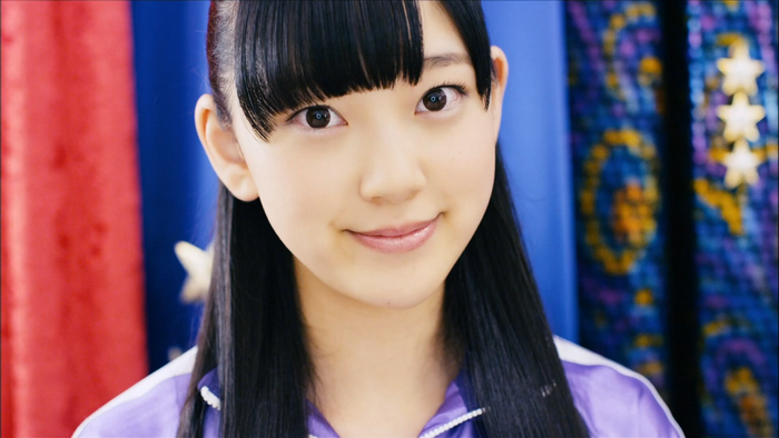 Girl with black hair and bangs, smiling
