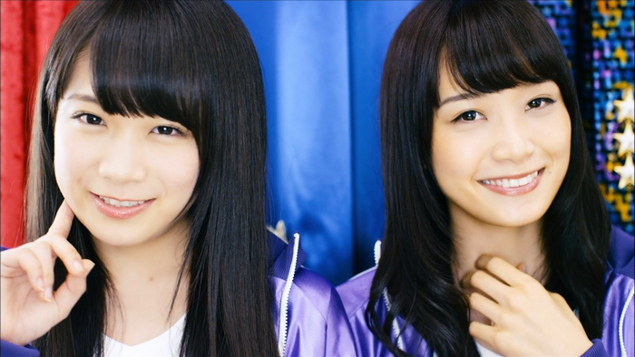 Two young Asian women with black hair smiling