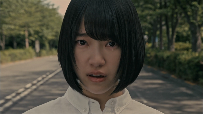 Young Asian woman with short black hair crying