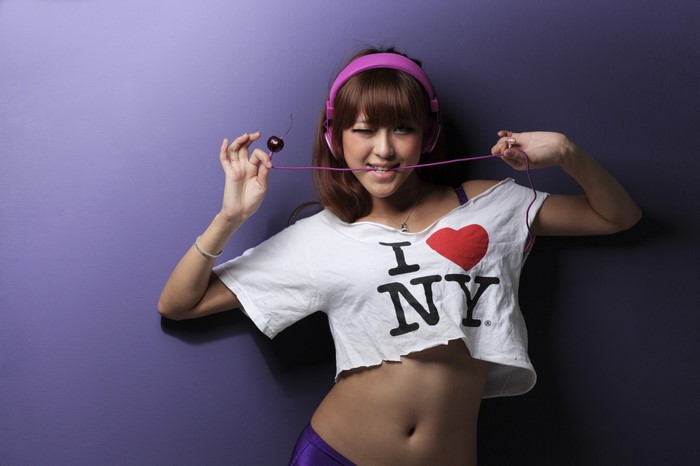 Asian woman with headphones and cherry