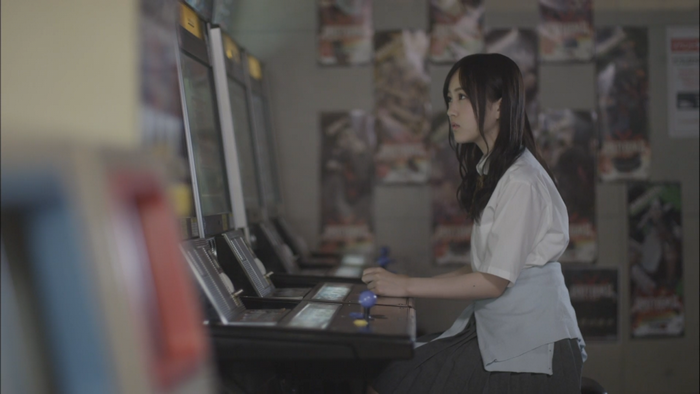 Young woman playing arcade game