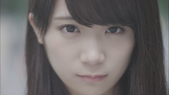 Close up portrait of a young Asian woman with long brown hair