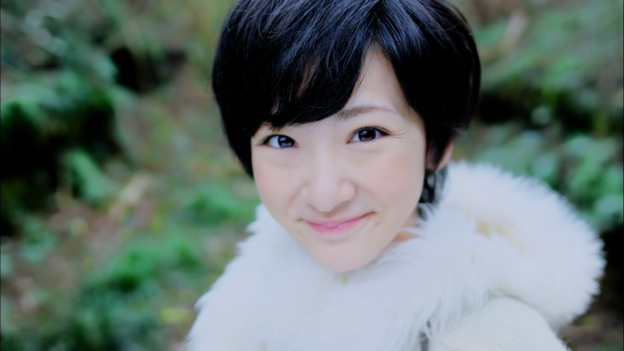 Asian woman with short black hair smiling outdoors