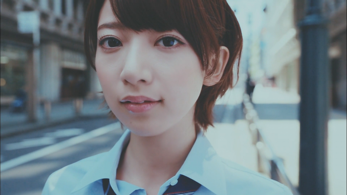 Asian woman with short auburn hair in a blue shirt