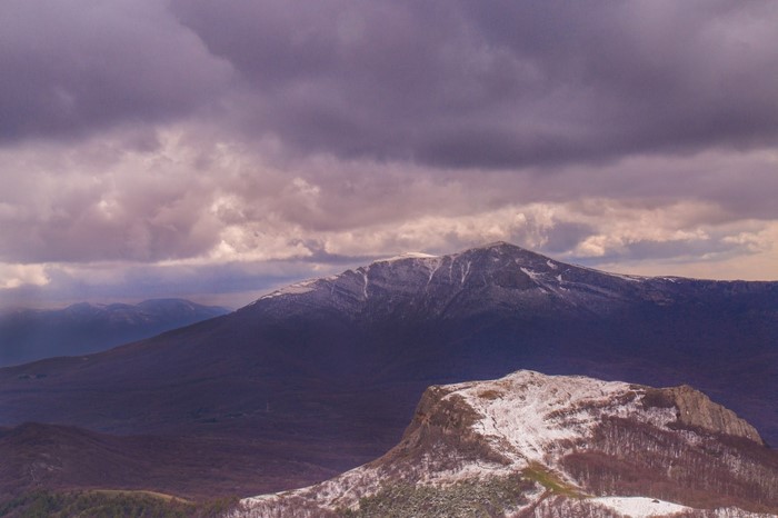 Snow-capped mountains under a cloudy sky