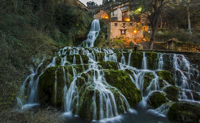 Waterfall cascading over mossy rocks near Orbaneja del Castillo, Spain