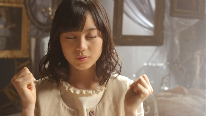 Asian woman with closed eyes and clenched fists