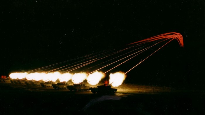 Tanks firing at night with tracer rounds
