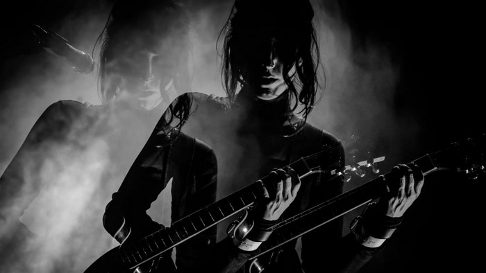 Chelsea Wolfe performing with a double-neck guitar