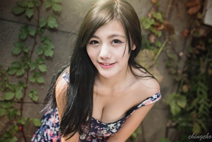 Smiling Woman with Long Black Hair in Floral Dress