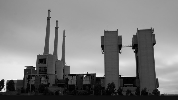 Abandoned industrial power plant with smokestacks and towers