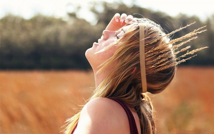 Woman with wheat crown in a field