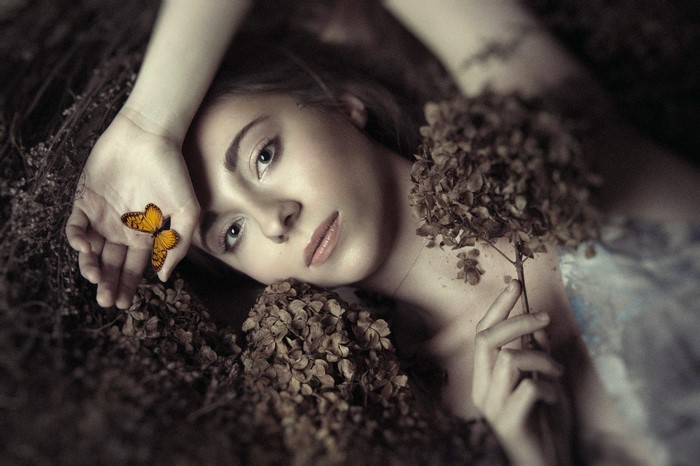 Woman with butterfly and dried flowers