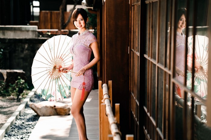 Woman in purple dress holding an umbrella