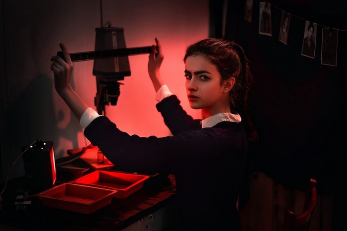 Woman developing film in a darkroom