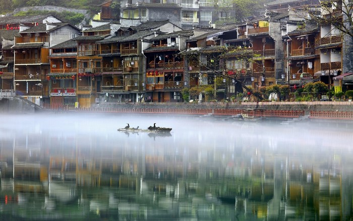 Phoenix Ancient Town, China, with birds on a raft