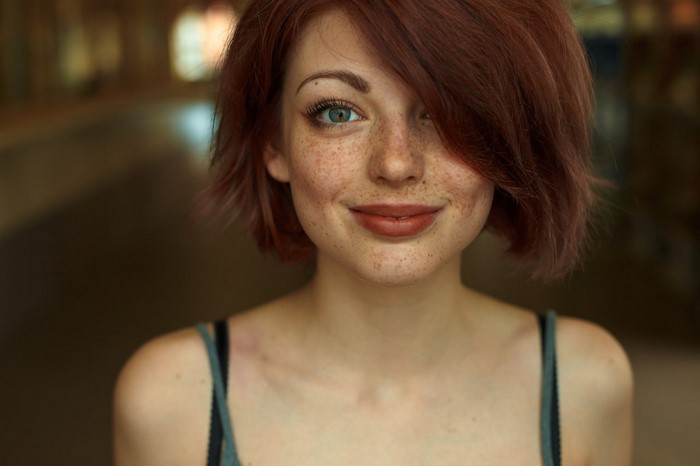 Close-up Portrait of Smiling Redhead Woman with Freckles