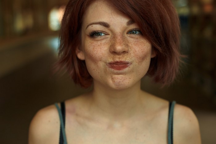 Close-up Portrait of Freckled Redhead Woman Smiling