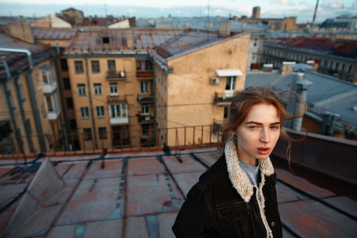 Woman with freckles on city rooftops