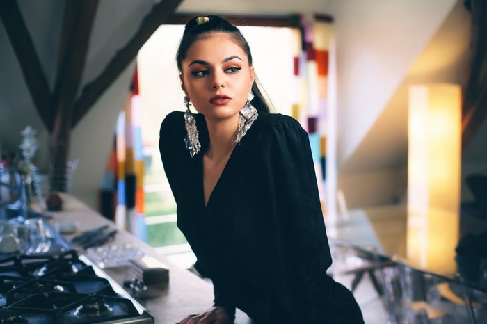 Woman with large earrings in black dress